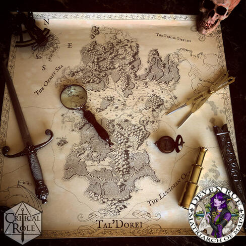 A photo of a hand-drawn illustrated map of Tal'Dorei from Critical Role created by Deven Rue surrounded by navigational tools and a dagger.